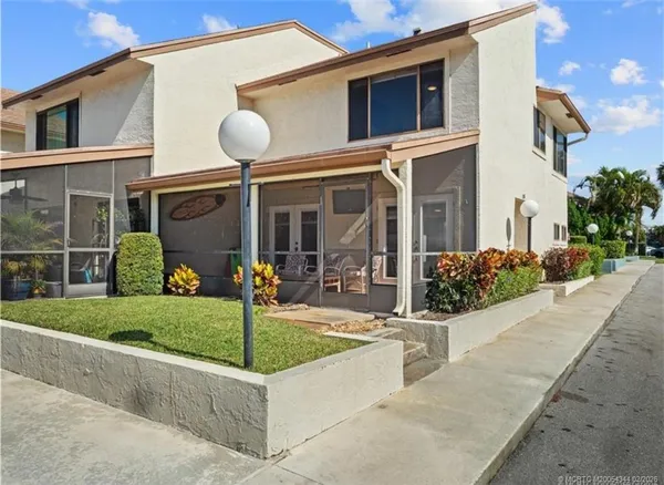 a view of a house with backyard and porch