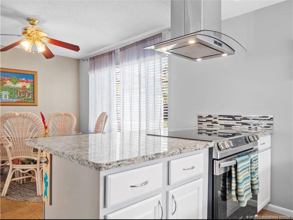 950 South Kanner Highway, Unit TH138 Stuart, FL 34994 - Photo 3 of 7 a kitchen with granite countertop a stove and a sink