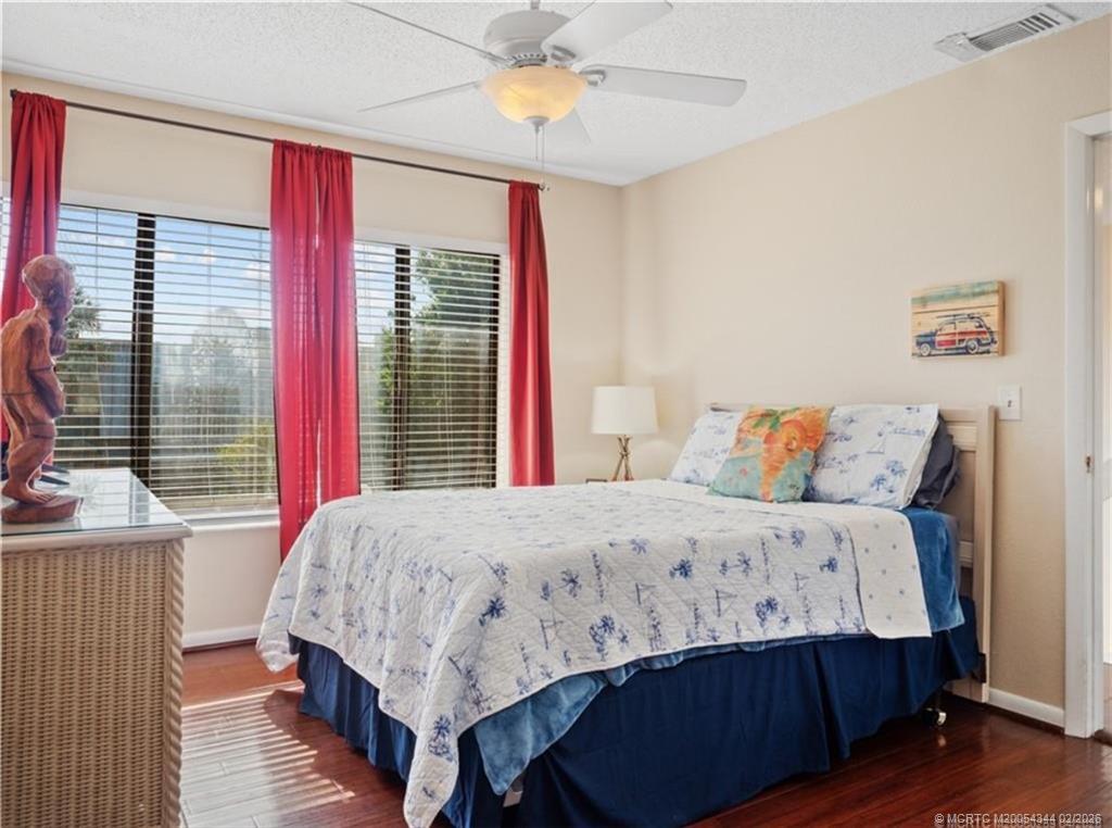 950 South Kanner Highway, Unit TH138 Stuart, FL 34994 - Photo 5 of 7 a bedroom with a bed and a chandelier