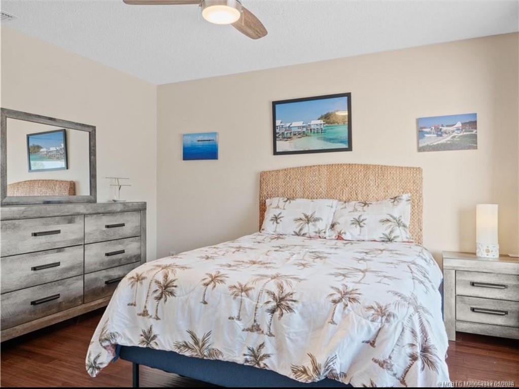 950 South Kanner Highway, Unit TH138 Stuart, FL 34994 - Photo 6 of 7 a bedroom with a bed and a lamp on dresser