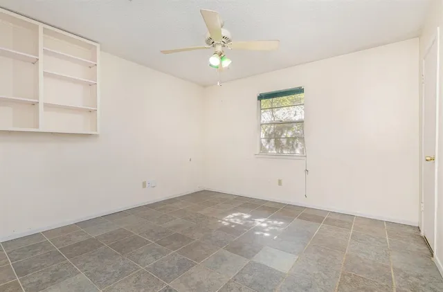 an empty room with cabinet and a window