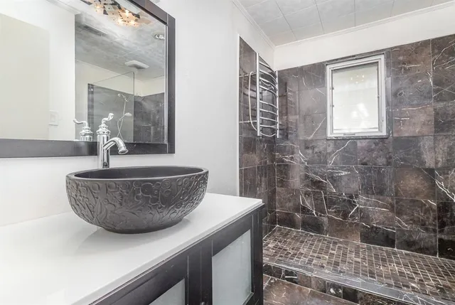 a bathroom with a sink a mirror and shower