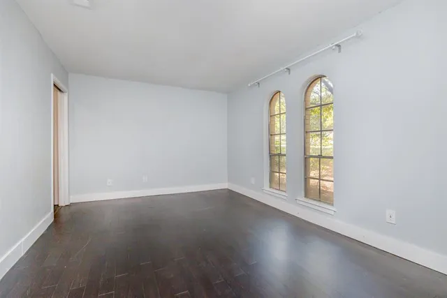 an empty room with windows and natural light