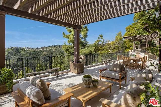 a view of balcony with couch and chairs