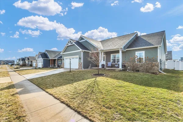 a view of a house with a swimming pool and a yard