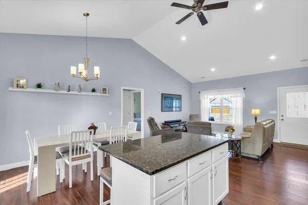 a kitchen with center island table and chairs in it