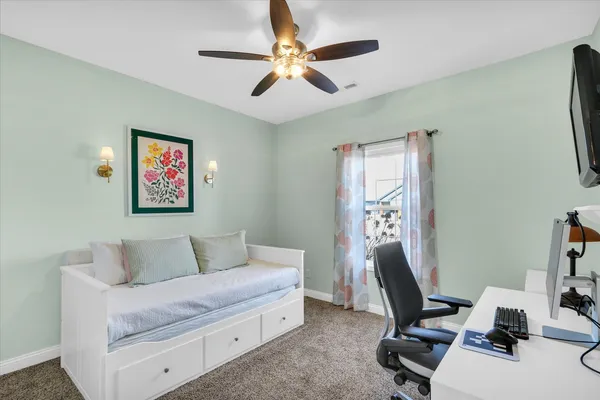 a bedroom with a workspace