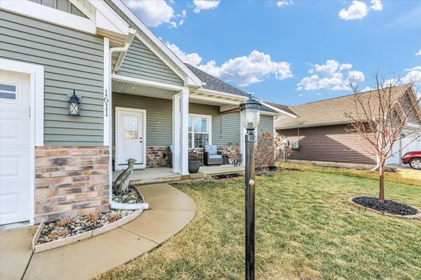 a view of a house with backyard porch and furniture