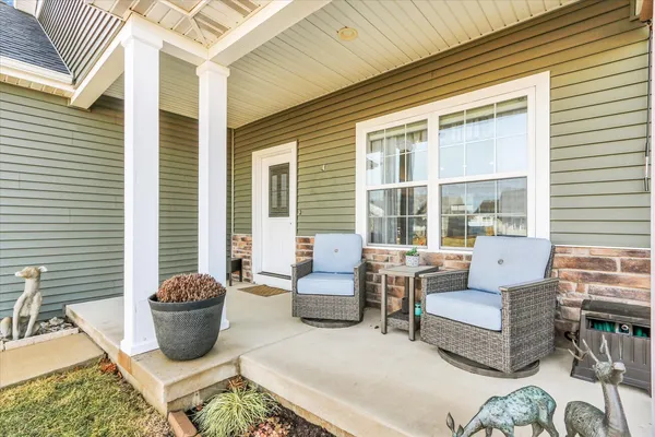 a living room filled with furniture and a potted plant