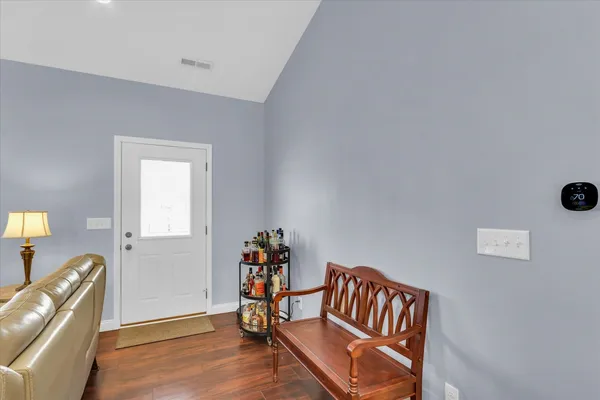 a living room with furniture and a wooden floor