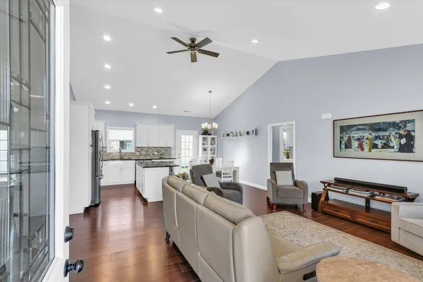 a living room with furniture and kitchen view