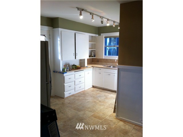 4001 Whitman Avenue North Seattle, WA 98103 - Photo 3 of 8 a large kitchen with a sink and cabinets