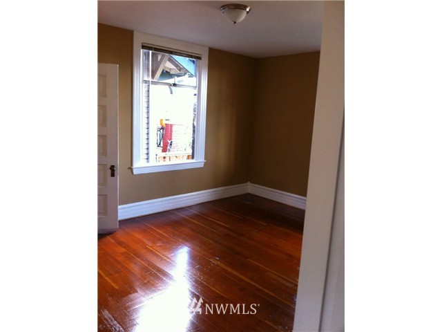 4001 Whitman Avenue North Seattle, WA 98103 - Photo 6 of 8 a view of an empty room with wooden floor and a window