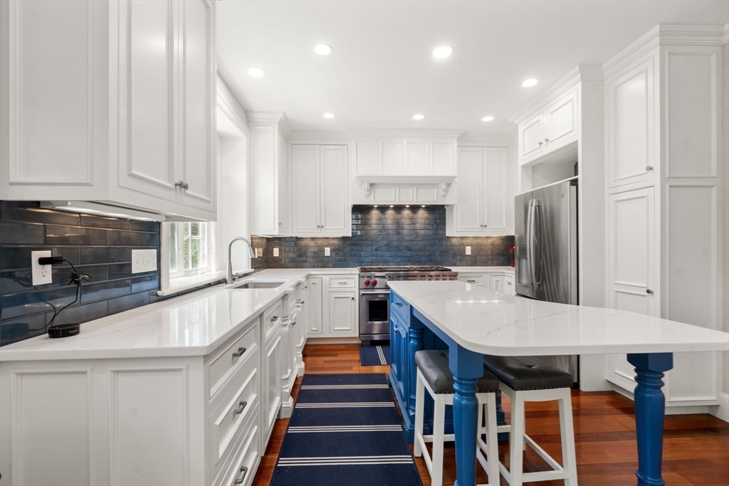 29 Maple Lane, Unit 29 Medfield, MA 02052 - Photo 14 of 42 a large kitchen with stainless steel appliances granite countertop a sink and a refrigerator