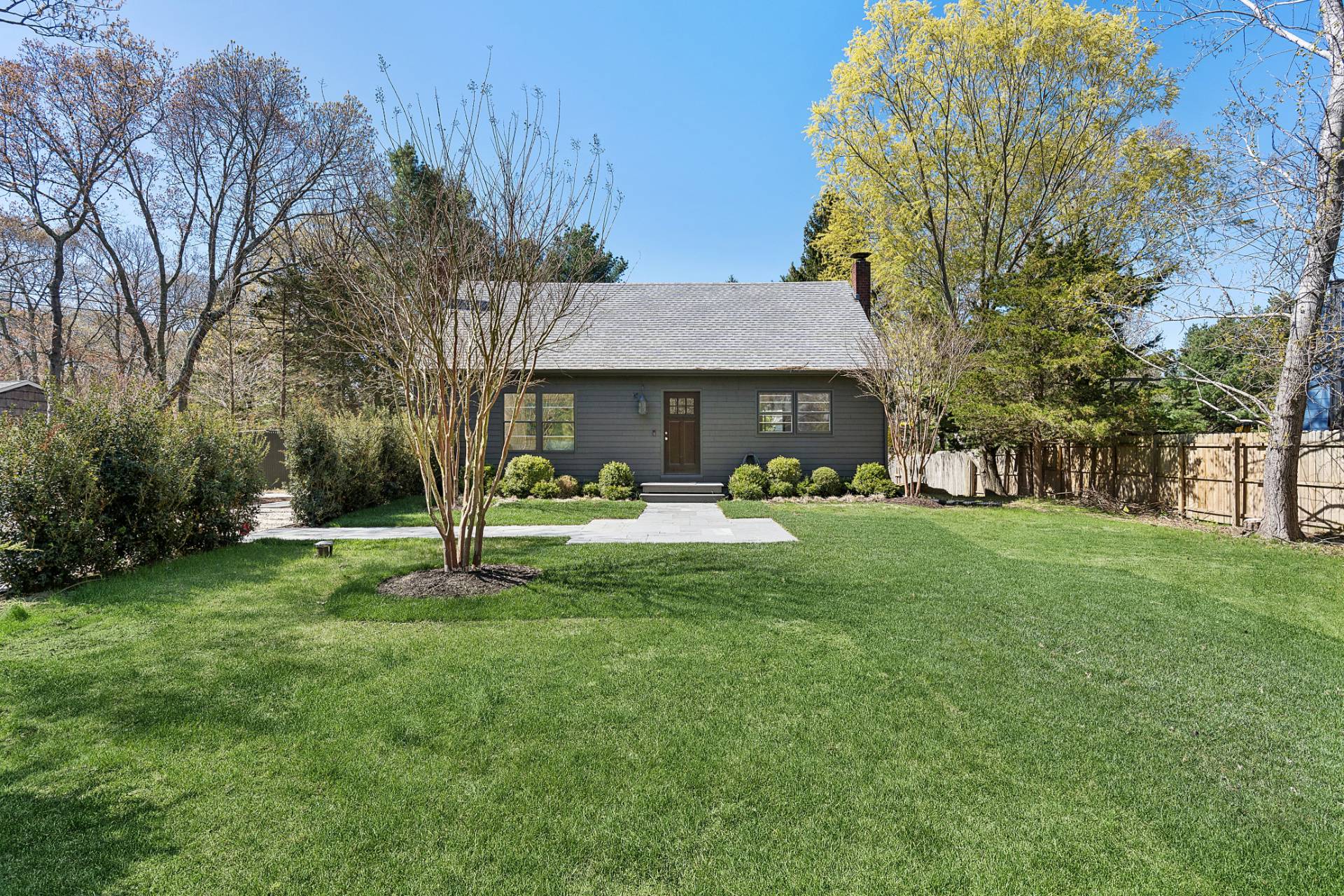 10 Glade Road East Hampton, NY 11937 - Photo 1 of 10 a front view of a house with garden and a tree