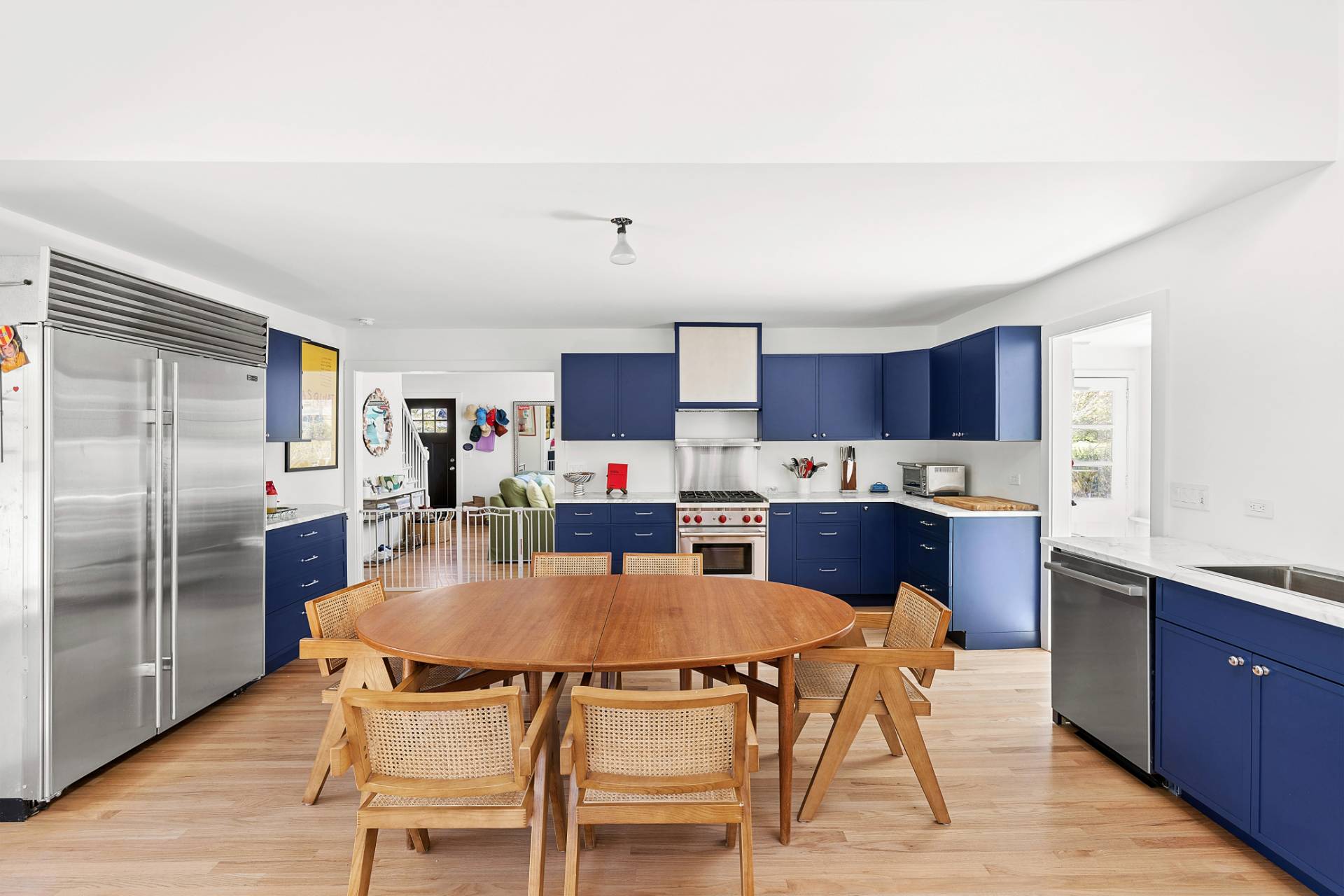 10 Glade Road East Hampton, NY 11937 - Photo 2 of 10 a kitchen with a table chairs refrigerator and cabinets