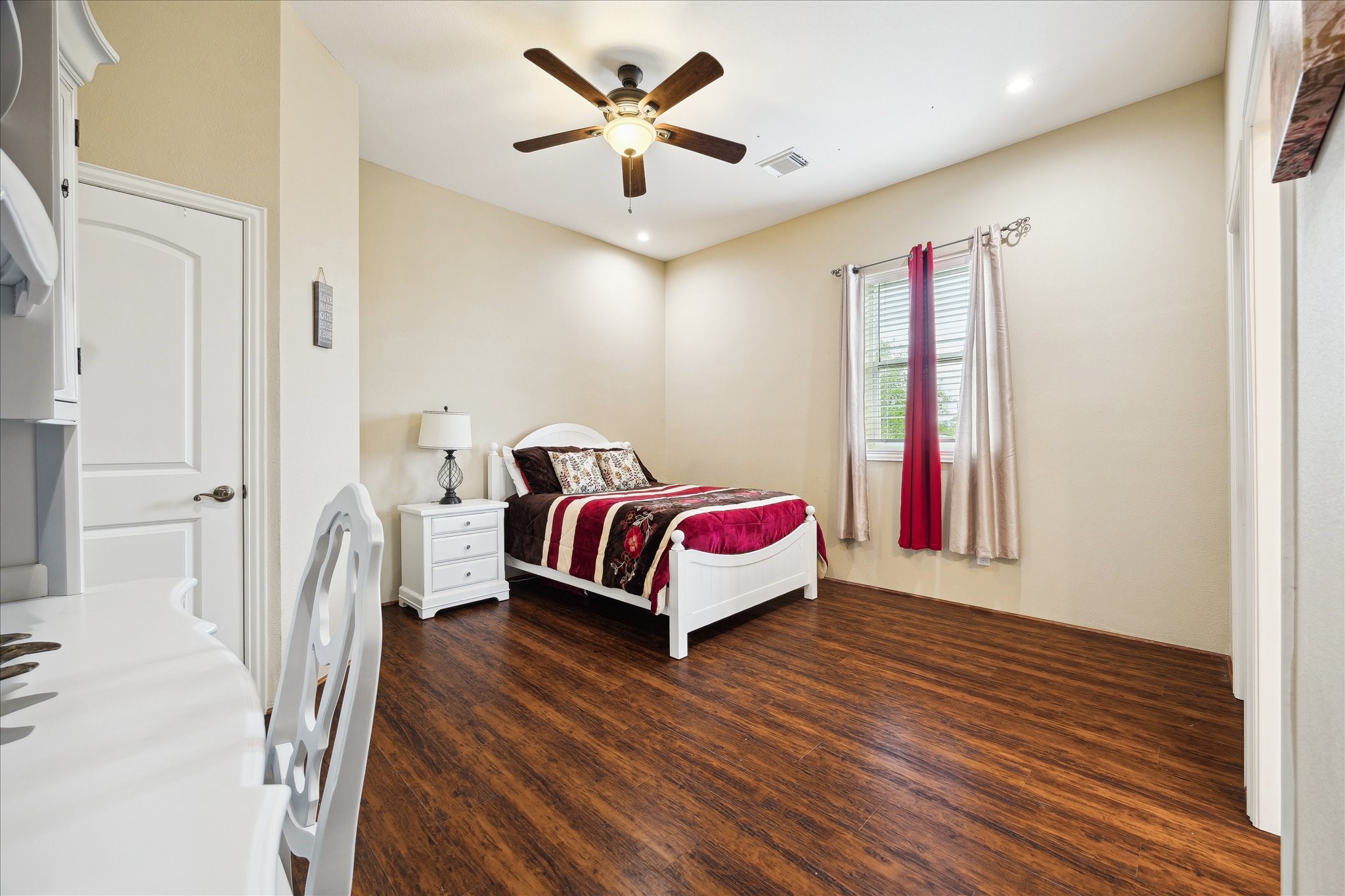 8917 Hawk Road Pearland, TX 77584 - Photo 18 of 33 a bed room with a bed and a chandelier