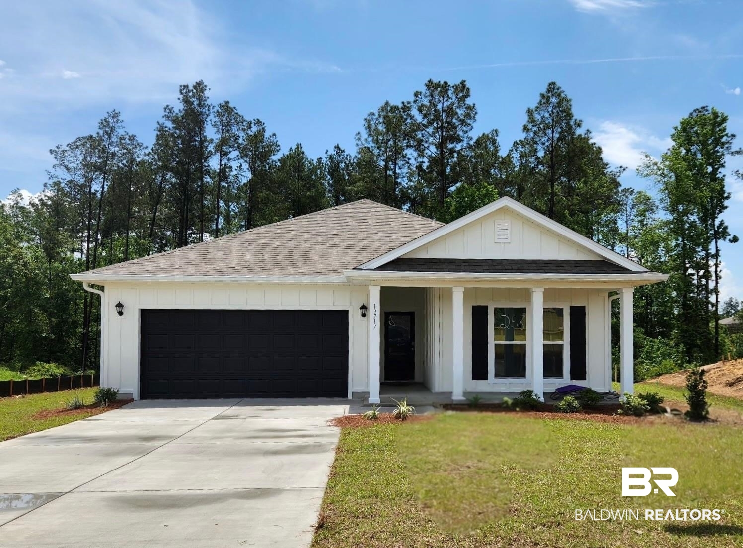 13717 Paris Circle Daphne, AL 36527 - Photo 1 of 38 View of front of house with roof with shingles, an attached garage, board and batten siding, a front yard, and concrete driveway