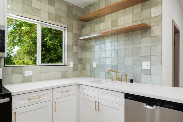 a view of an empty room with glass door and a window