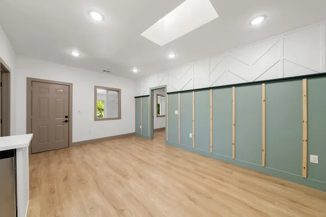 a spacious bathroom with a granite countertop sink and a mirror