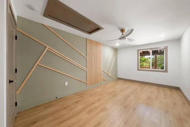 a kitchen with stainless steel appliances granite countertop a refrigerator a sink dishwasher a stove with wooden cabinets and floor