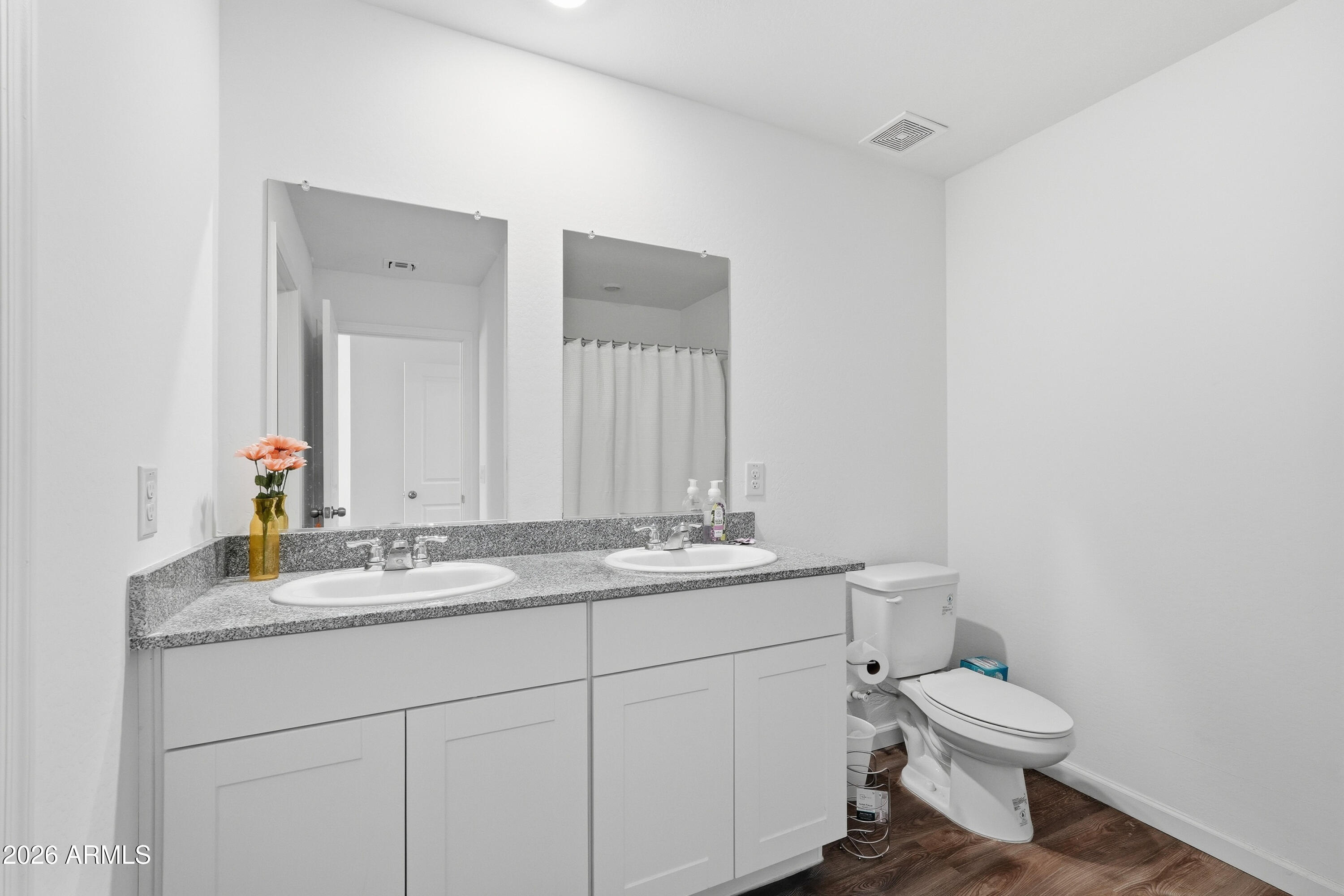 15610 South Moon Valley Road Arizona City, AZ 85123 - Photo 26 of 36 a bathroom with a granite countertop toilet sink mirror and vanity