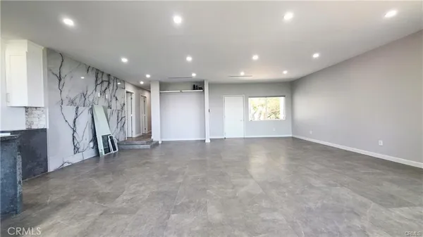 a kitchen with granite countertop stainless steel appliances a stove sink and microwave