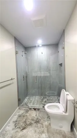 a view of room with a piano and wooden floor