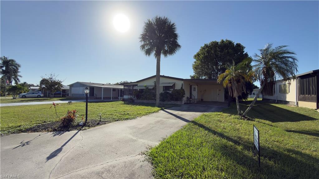 207 Riverwood Road Naples, FL 34114 - Photo 1 of 13 a house view with a garden space