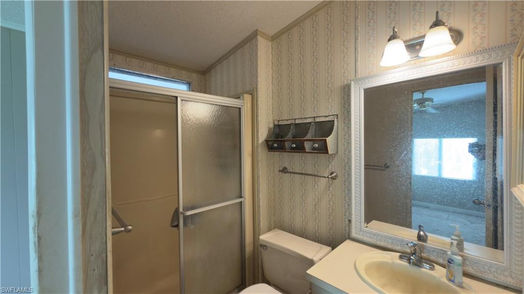 207 Riverwood Road Naples, FL 34114 - Photo 11 of 13 a bathroom with a sink toilet and shower