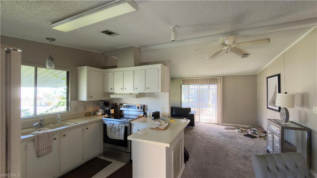 207 Riverwood Road Naples, FL 34114 - Photo 5 of 13 a kitchen with a sink stove and refrigerator