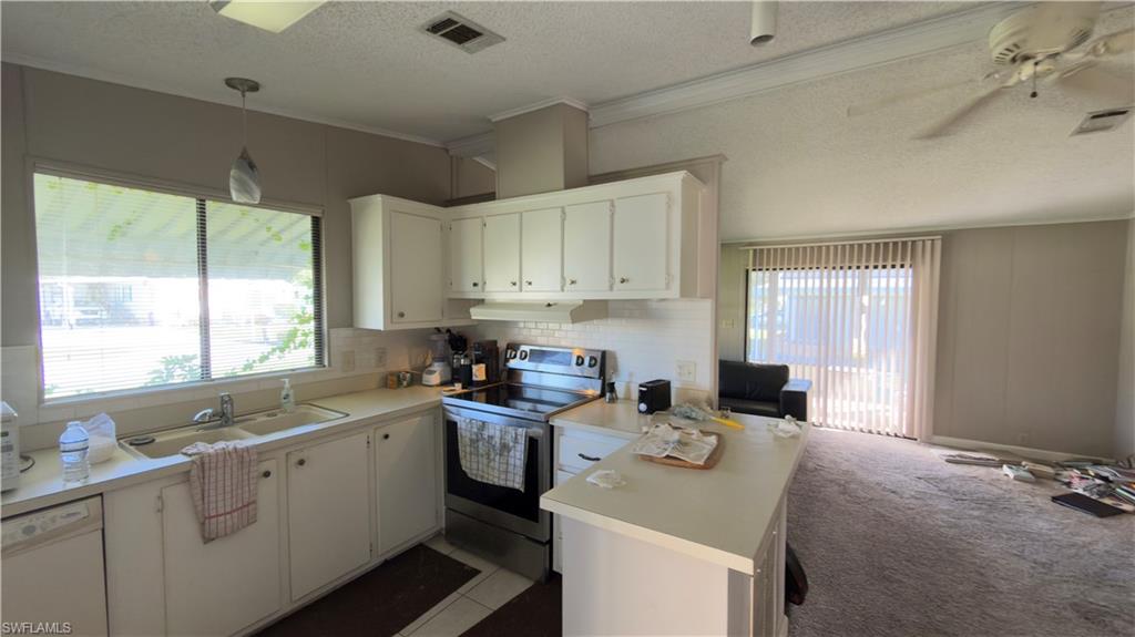 207 Riverwood Road Naples, FL 34114 - Photo 6 of 13 a kitchen with a sink stove top oven and cabinets