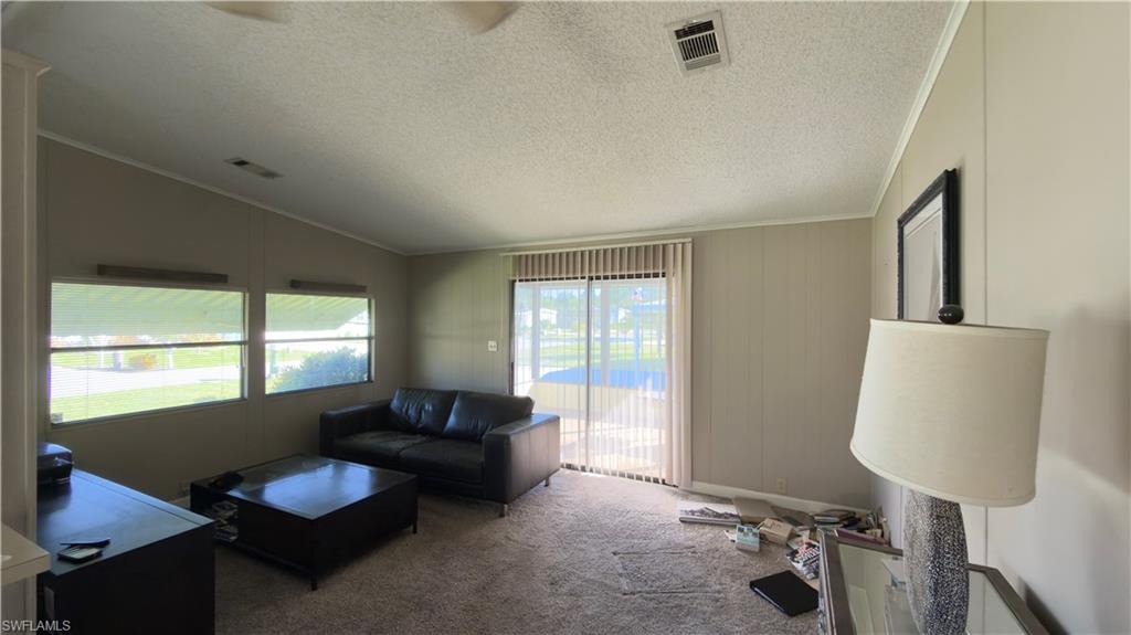 207 Riverwood Road Naples, FL 34114 - Photo 8 of 13 a living room with furniture and a window