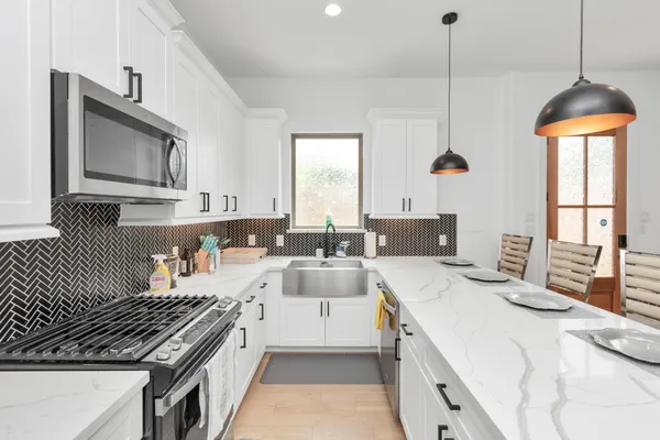 a kitchen with stove a sink and cabinets