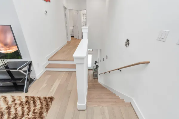 a view of entryway and hall with wooden floor