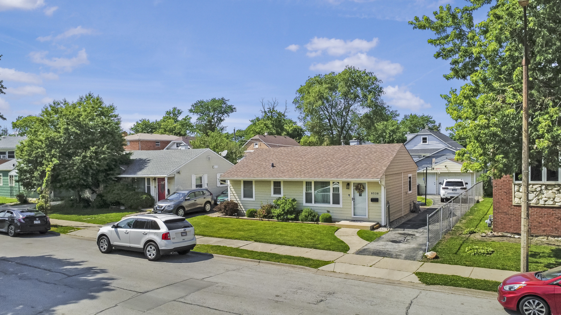 8538 45th Street Lyons, IL 60534 - Photo 1 of 29 a front view of a house with a garden and parking