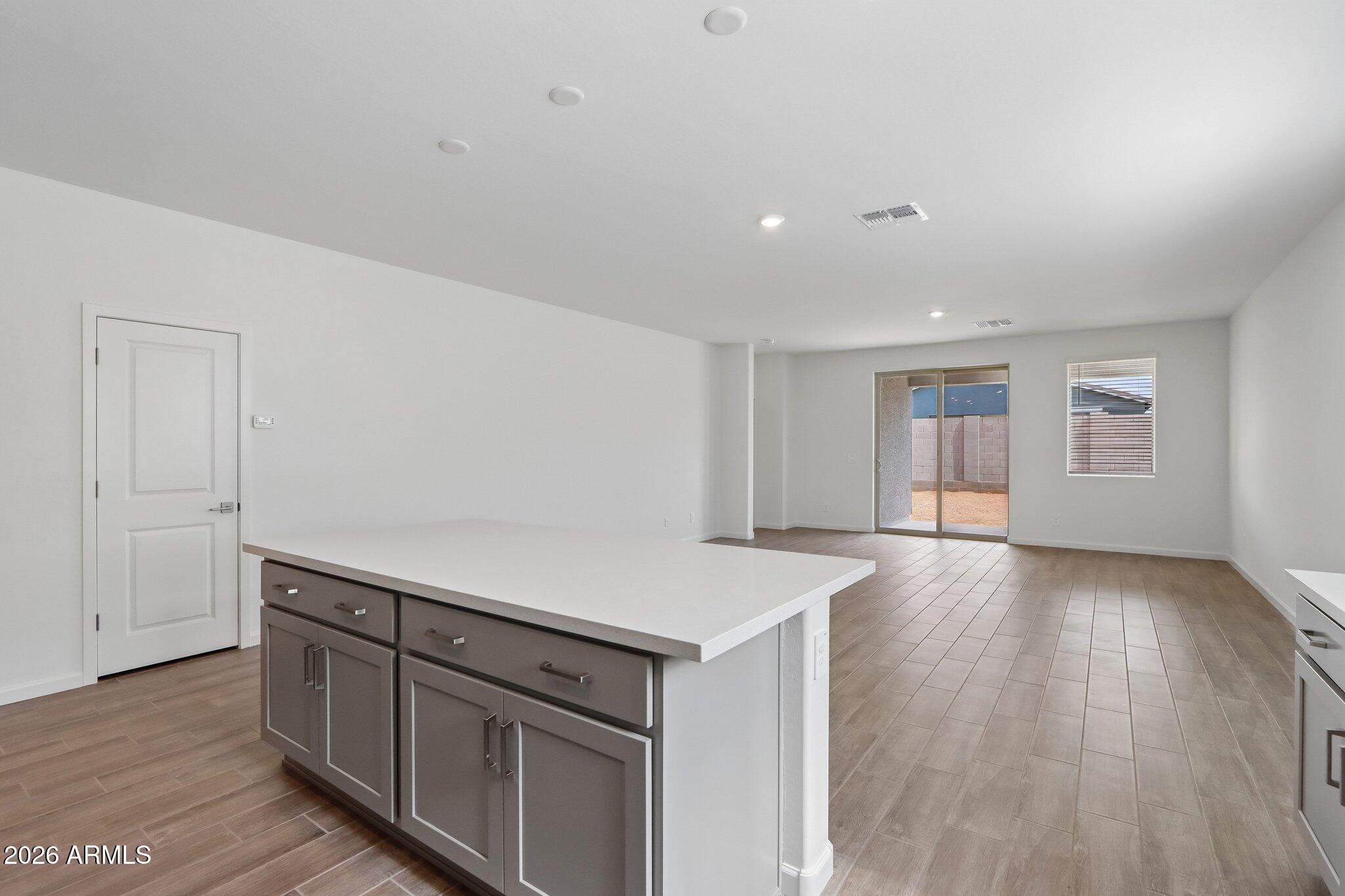 9544 West Gaby Road Tolleson, AZ 85353 - Photo 10 of 43 a kitchen with cabinets wooden floor and a sink