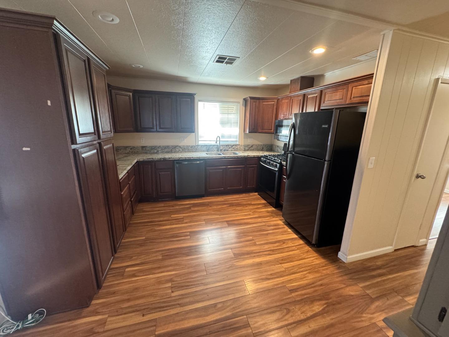 55 San Juan Grade Road, Unit 18 Salinas, CA 93906 - Photo 3 of 6 a view of a kitchen with refrigerator and window