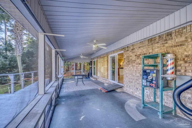 a view of a patio with table and chairs with wooden floor and fence