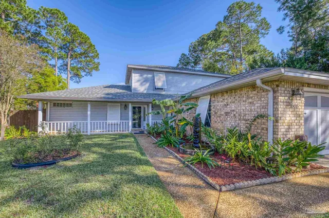 a front view of a house with garden