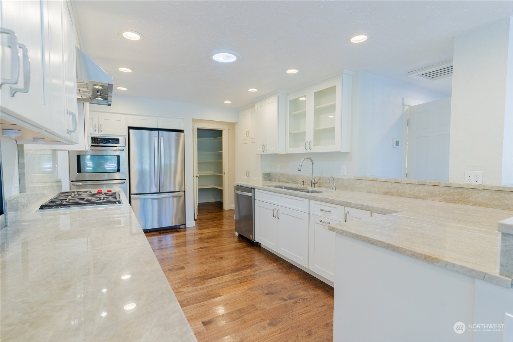 4110 Thornton Road Southeast Olympia, WA 98513 - Photo 13 of 40 a large kitchen with stainless steel appliances kitchen island granite countertop a refrigerator and a sink