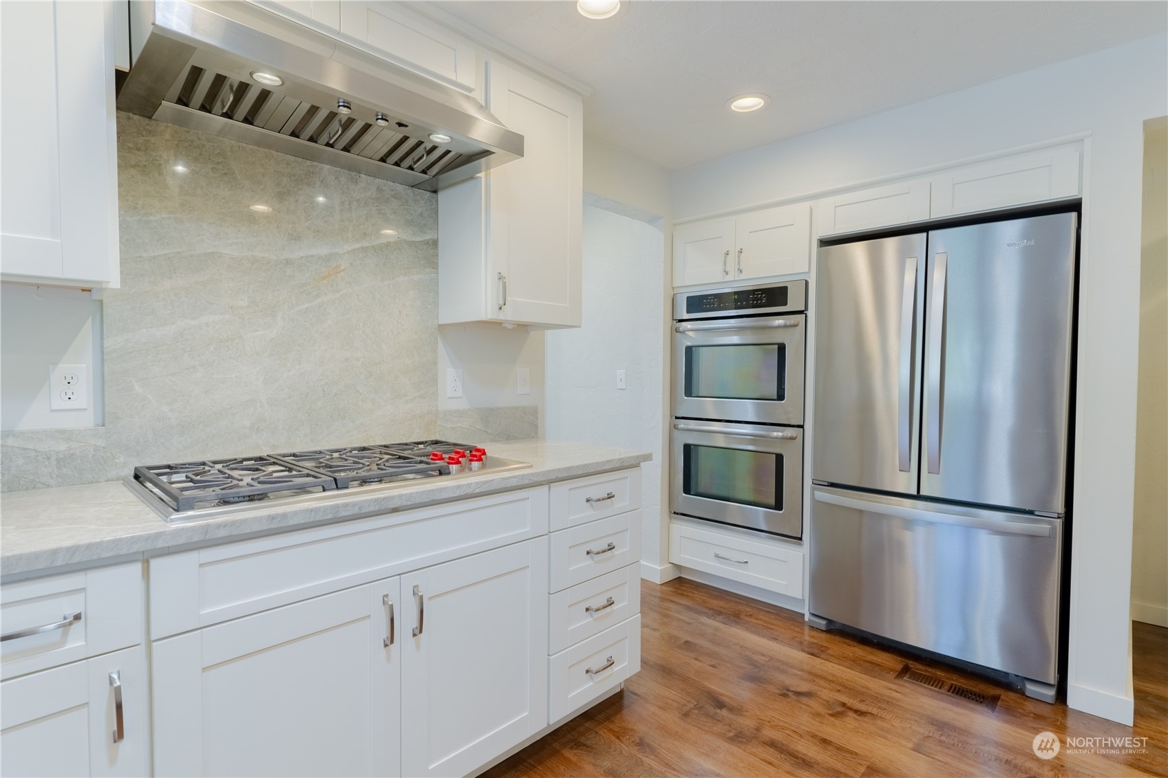 4110 Thornton Road Southeast Olympia, WA 98513 - Photo 14 of 40 a kitchen with white cabinets and stainless steel appliances
