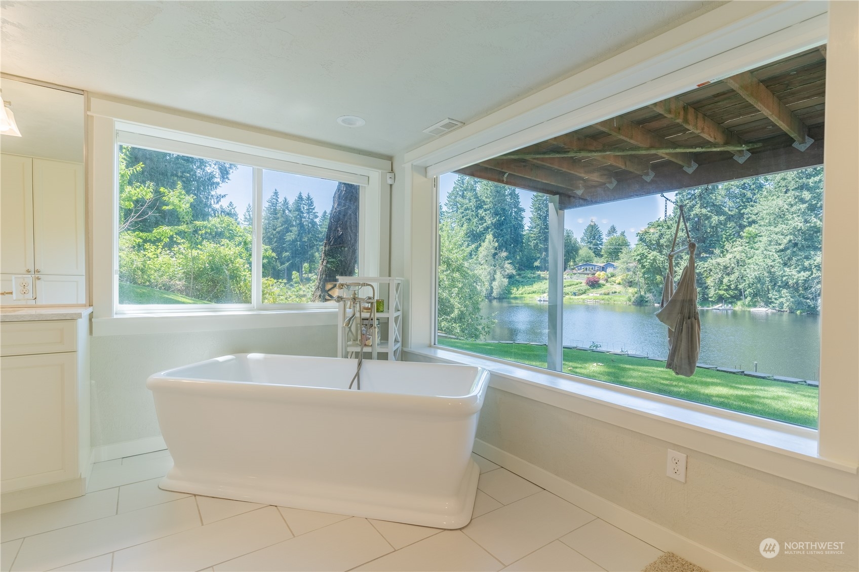 4110 Thornton Road Southeast Olympia, WA 98513 - Photo 29 of 40 a white bath tub sitting in a bathroom next to a large window