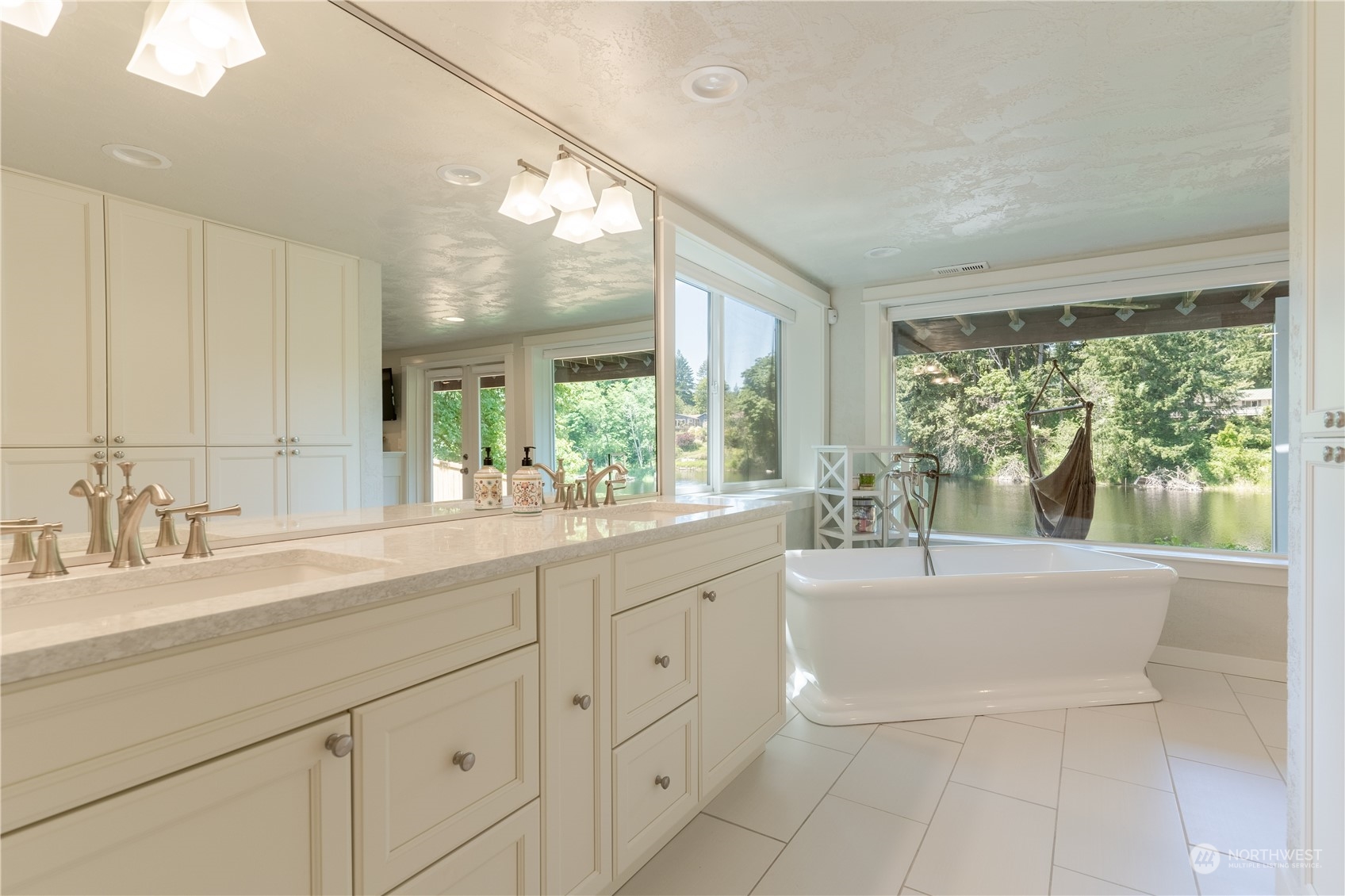 4110 Thornton Road Southeast Olympia, WA 98513 - Photo 32 of 40 a spacious bathroom with a tub sink and large mirror