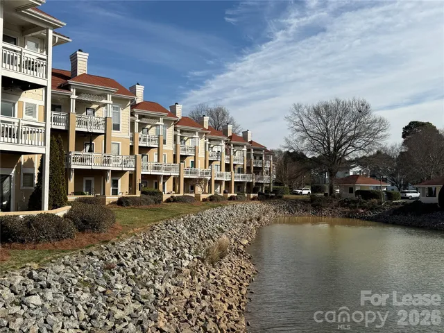 a view of residential houses with outdoor space and lake view