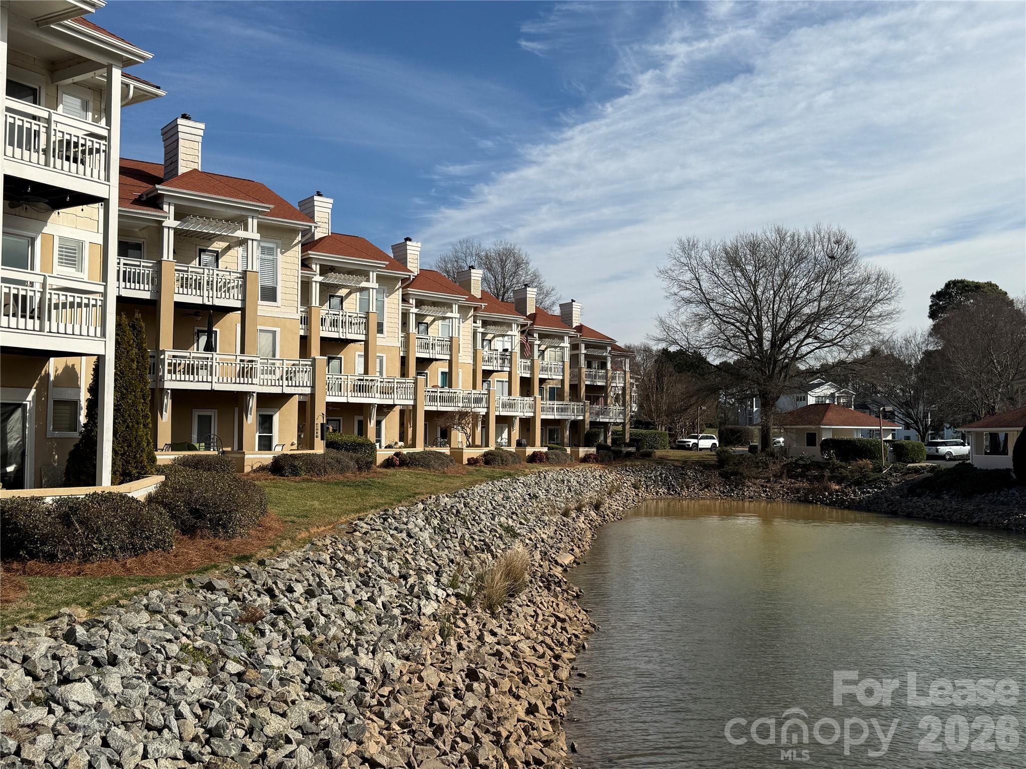 a view of residential houses with outdoor space and lake view