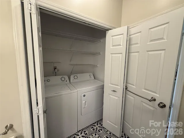 a view of bathroom with a washer and dryer