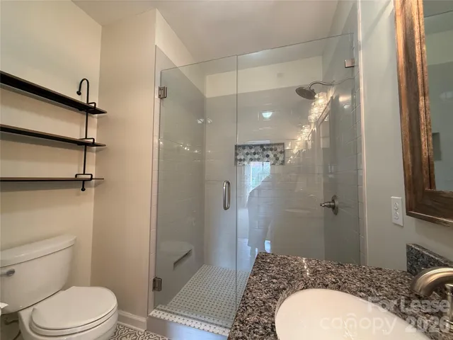 a bathroom with a sink toilet and shower