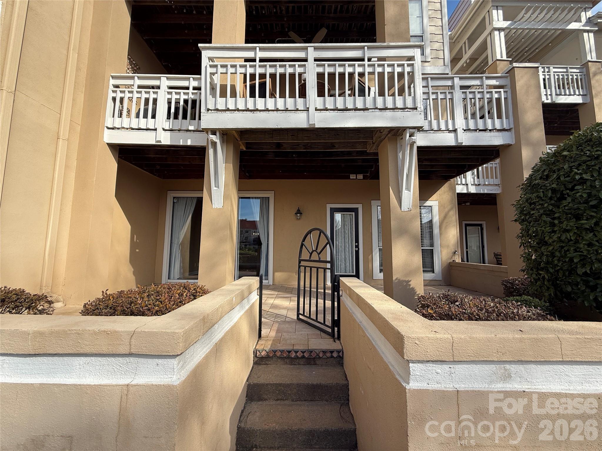 18009 Kings Point Drive, Unit M Cornelius, NC 28031 - Photo 27 of 34 a front view of a house with glass windows