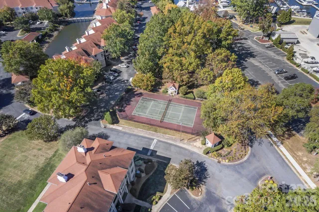 an aerial view of lake and residential houses with outdoor space